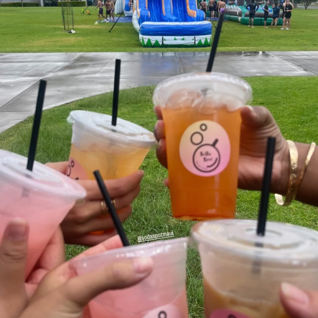A bright pink SoDaSpot dirty soda in a branded cup